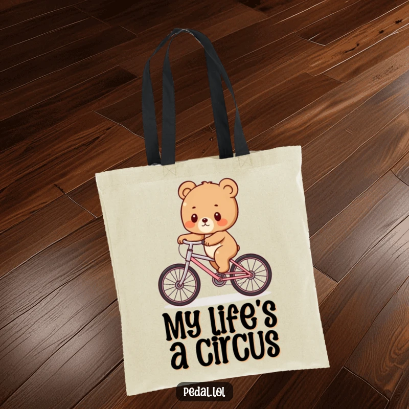 Funny Bear Cub Wobble Tote Bag: A charming tote featuring a bear cub hilariously balancing on a bike, ideal for a funny gift.